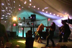 Dancers enjoying the dance floor setup under the tent.