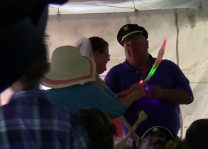 The bride and groom make use of a pirate cutlass to cut the cake.